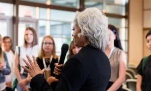 Professional woman addressing a group of peers