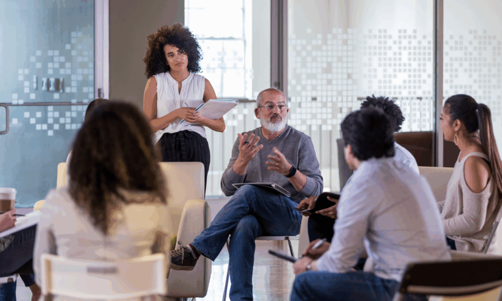 Male senior leader speaking to a group of employees