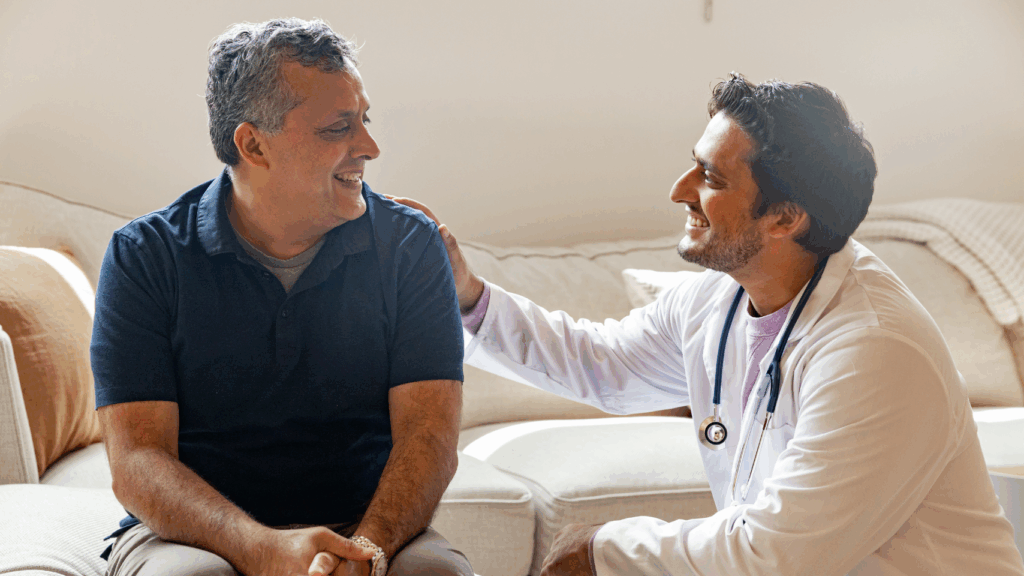 Male doctor comforting male patient