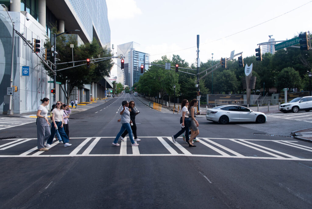 A group of professionals walk across the street in Atlanta