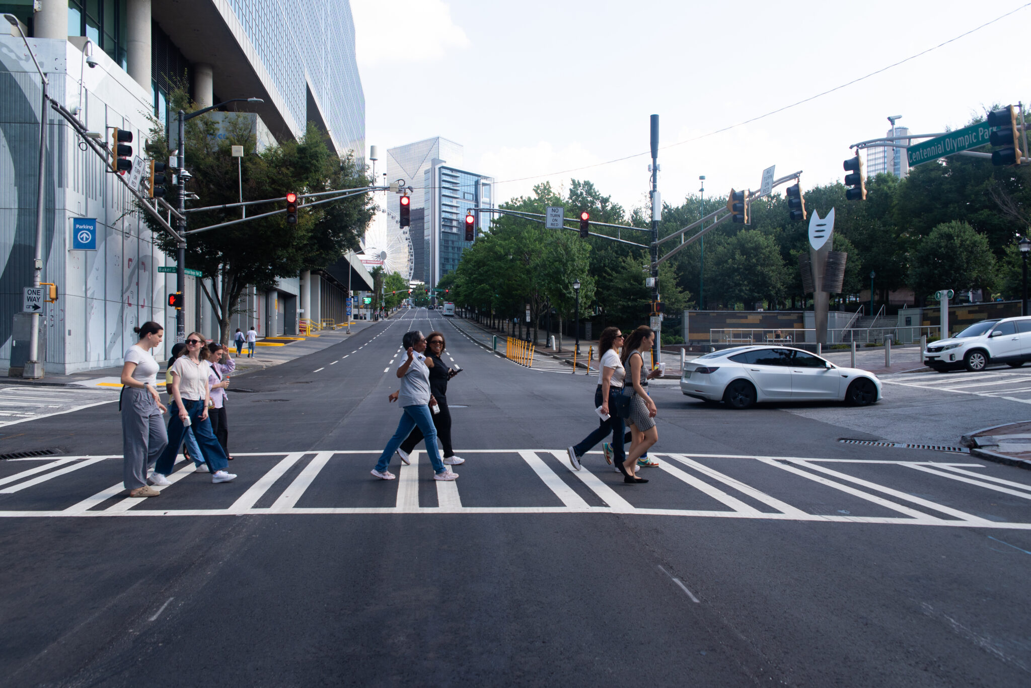 A group of professionals walk across the street in Atlanta