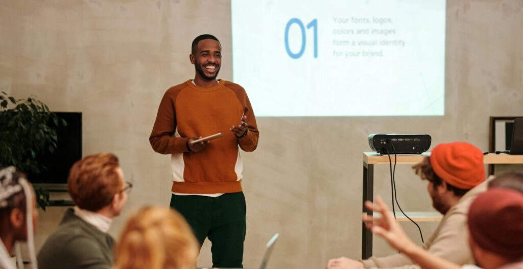 Man giving a lecture in front of a projector