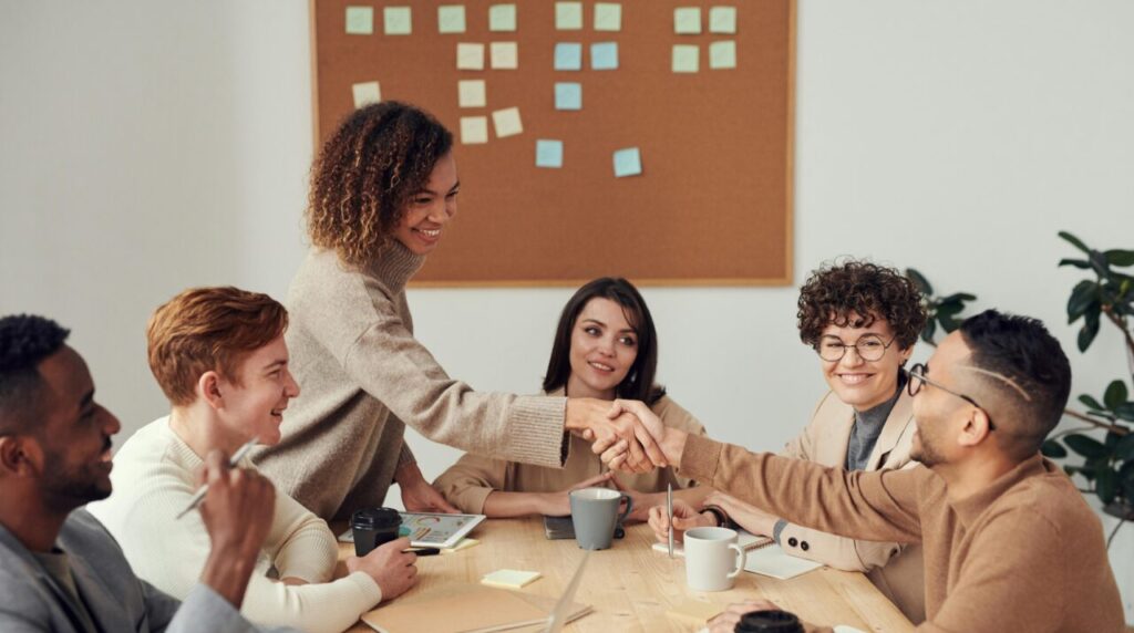 Team working together around a conference room table.