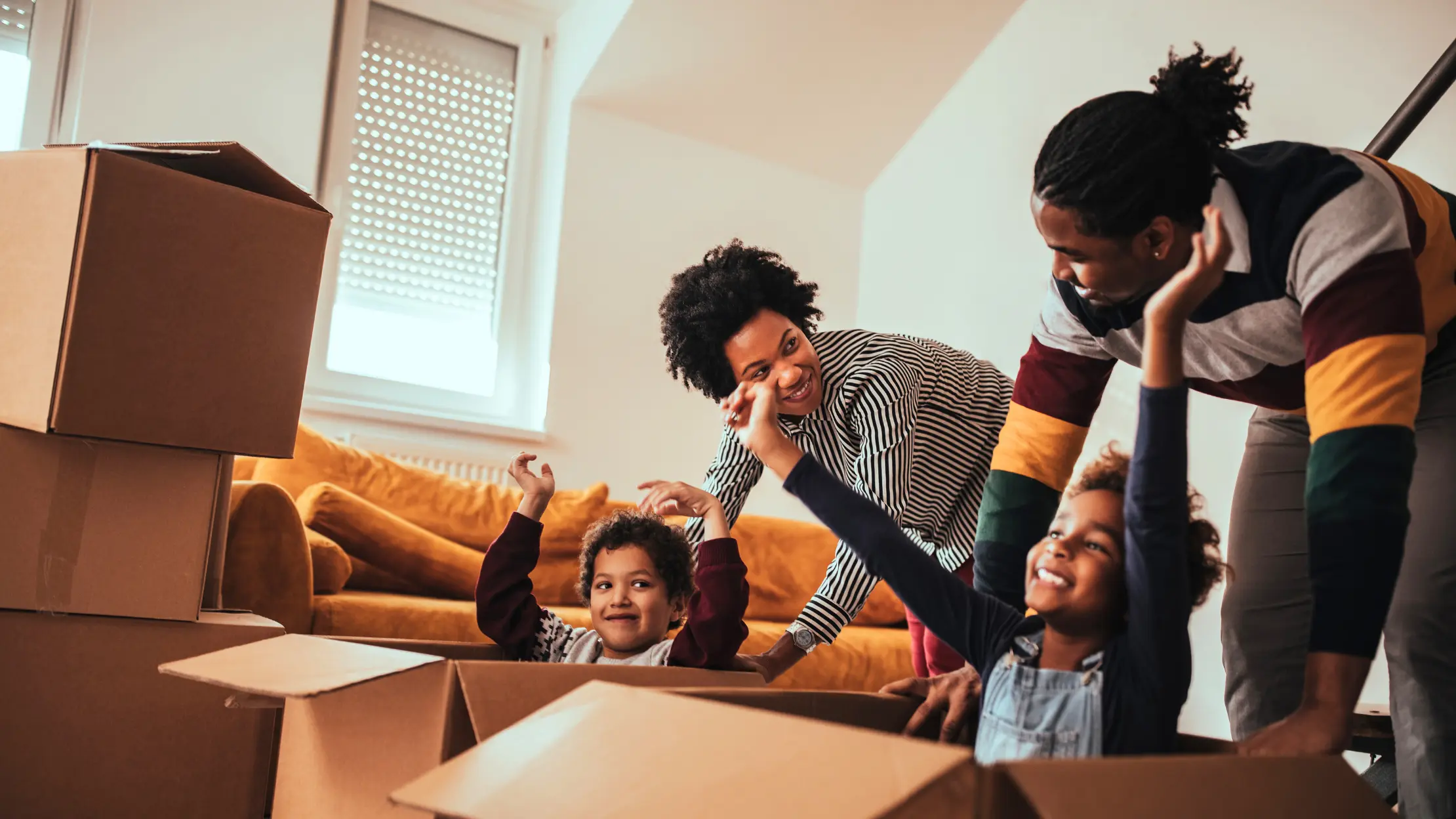 A happy young family amongst boxes on moving day