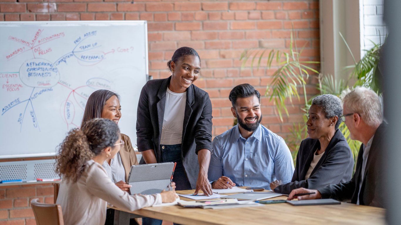 A diverse group of leaders meeting in a casual office setting