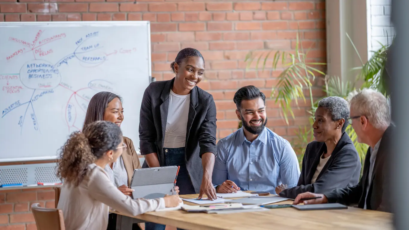 A diverse group of leaders meeting in a casual office setting