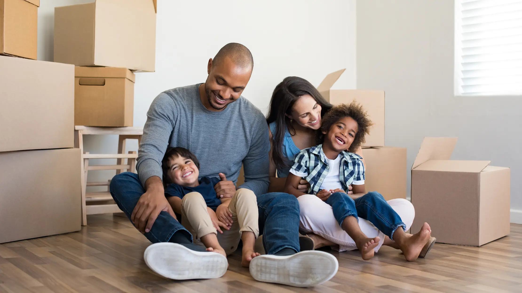 Young family among boxes on moving day